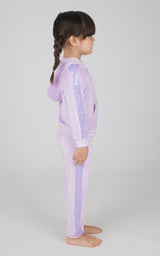 Toddler girl wearing orchid bloom velour hoodie jacket and matching jogger pants set, side view.