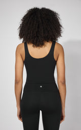 Black fitted tank top with built-in bra, scoop back, and wide straps on model.
