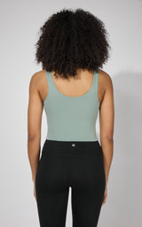Women's sleeveless clover green tank top with built-in bra and scoop back neckline.