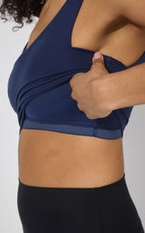 Naval blue tank top with built-in bra, fitted stretch fabric, wide shoulder straps.