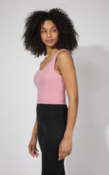 Pink plum tank top with built-in bra, fitted style, worn with black leggings.