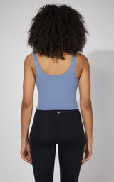 Women's naval blue tank top with built-in bra, scoop back, fitted style.