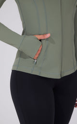 Mountain Sage full zip runner jacket with thumbhole cuffs and zippered side pocket.
