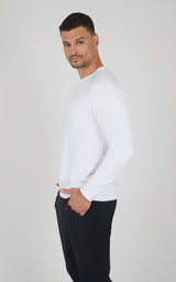 Men's white terry brushed crewneck long sleeve top with relaxed fit and ribbed cuffs.