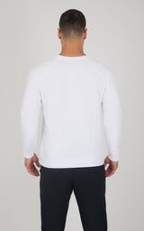 Men's white terry brushed long sleeve crewneck top, slim fit, paired with black pants, back view.