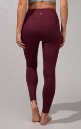 High waist fleece-lined legging in deep burgundy with side pockets, fitted silhouette.