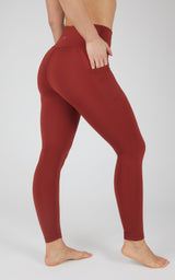 High waist fleece-lined leggings in deep red with side pockets and a smooth, fitted silhouette.