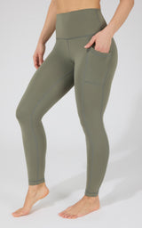 High waist olive green fleece-lined leggings with side pockets, fitted style.