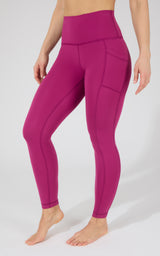 High waist fleece-lined leggings in vibrant plum violet with side pockets and smooth seams.