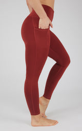 High waist fleece-lined leggings in deep red with side pockets and a smooth, fitted silhouette.