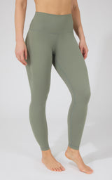 Women's high-waist power flex leggings in muted military green, smooth fabric, full length.