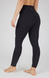 Black full-length tech leggings with high waist and smooth, fitted design on a barefoot model.