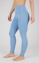 Light blue full-length high-waist leggings with smooth, fitted fabric on a standing model.