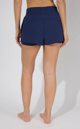Women's navy blue running shorts with a wide waistband and curved hem.