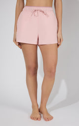Light pink stretch woven 2-in-1 running shorts with drawstring waist and relaxed fit.