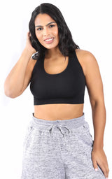 Plus-size black seamless racerback bra with wide straps and a smooth finish on model.