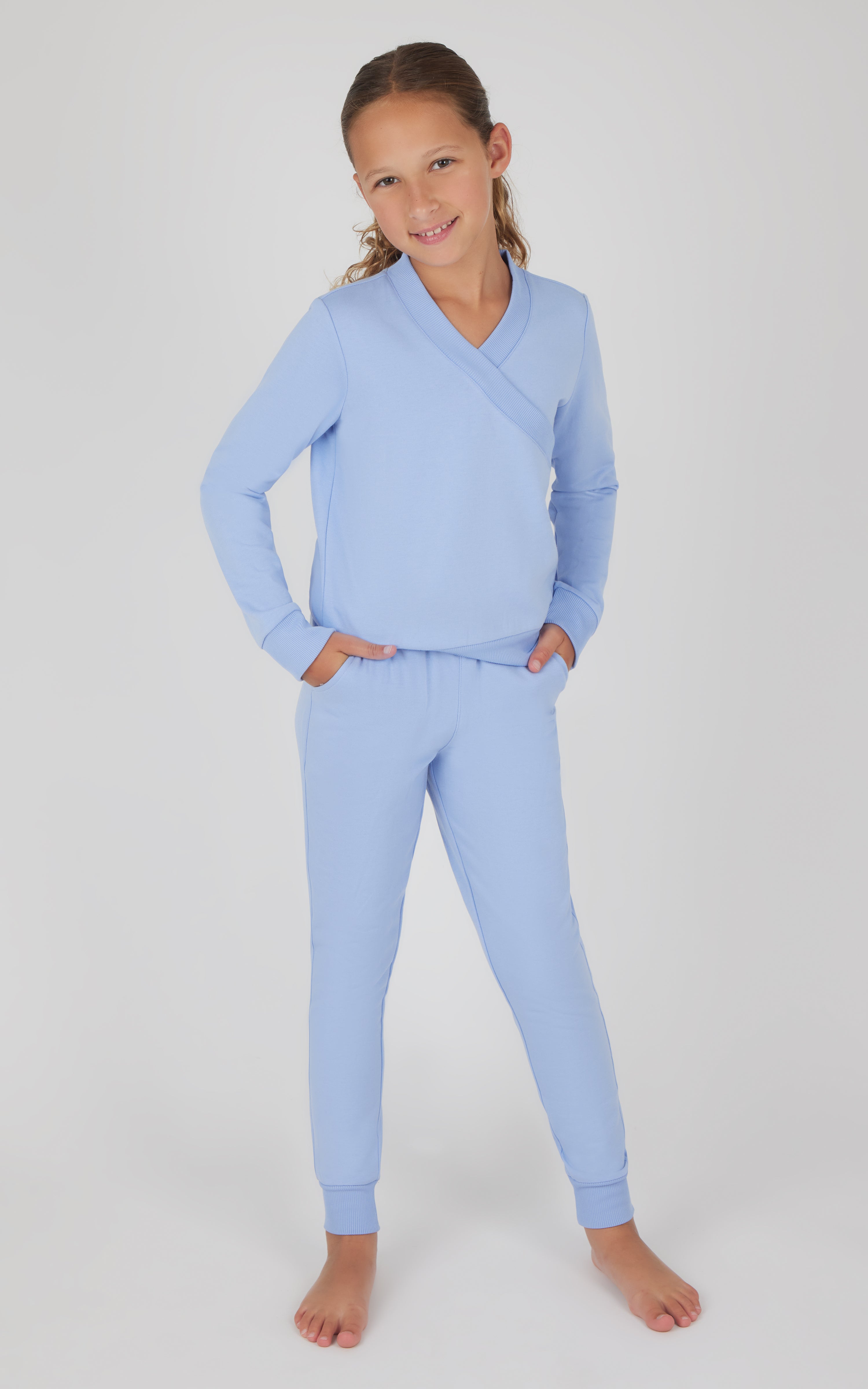 Girls light blue terry crossover long sleeve top with matching brushed jogger pants.