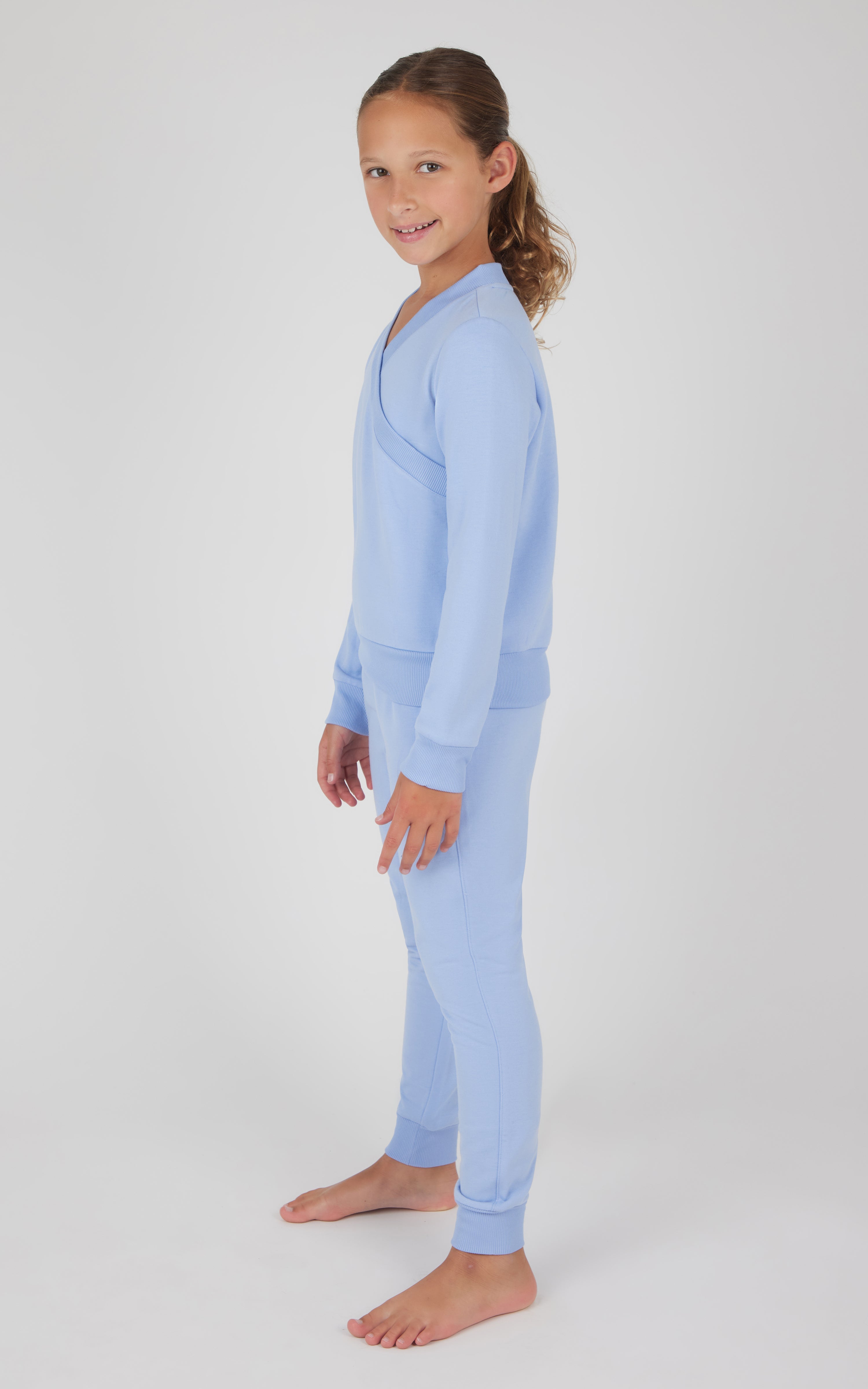 Girls light blue terry crossover long sleeve top and matching brushed joggers set.