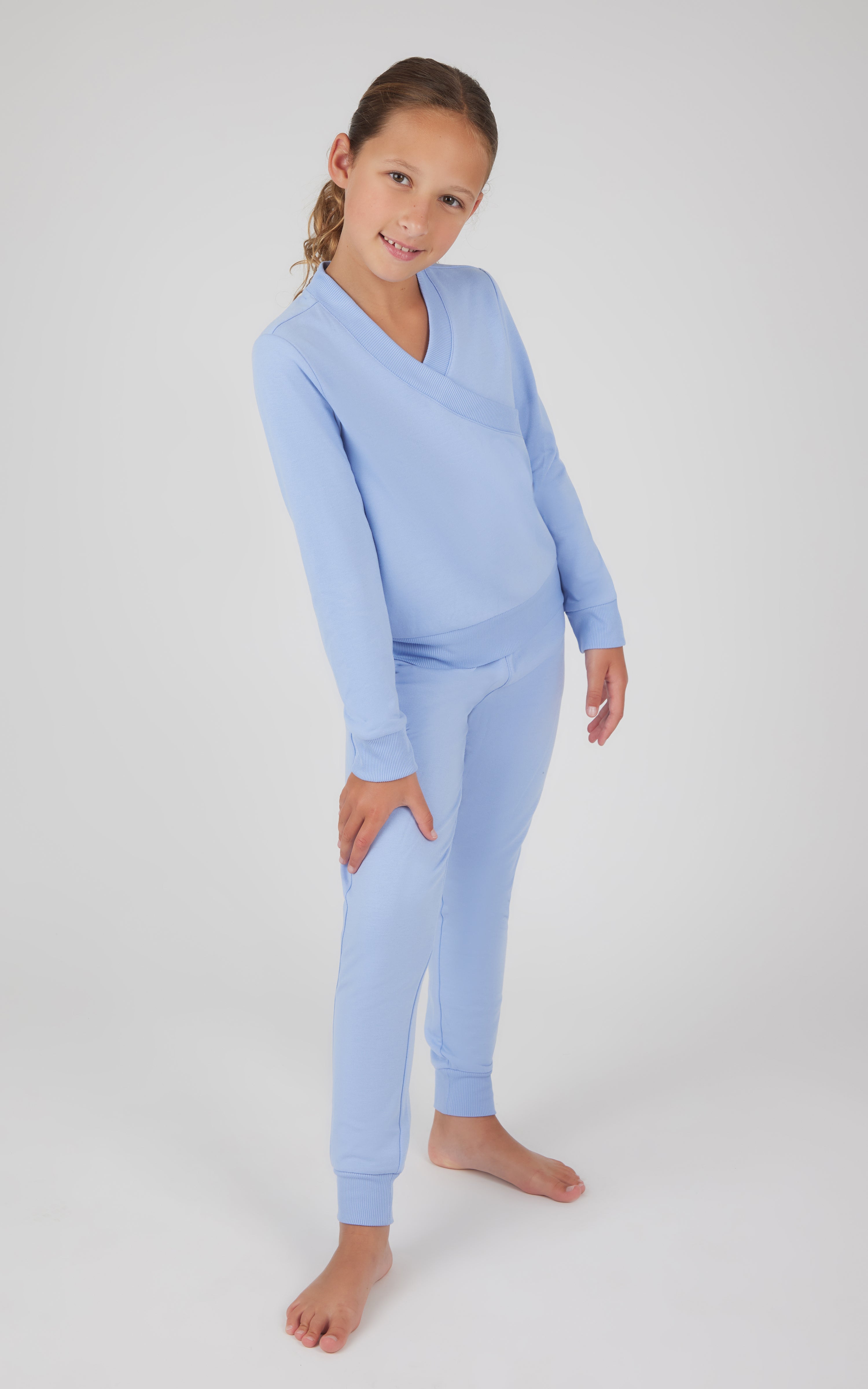 Girls light blue terry crossover long sleeve top with matching brushed jogger pants.