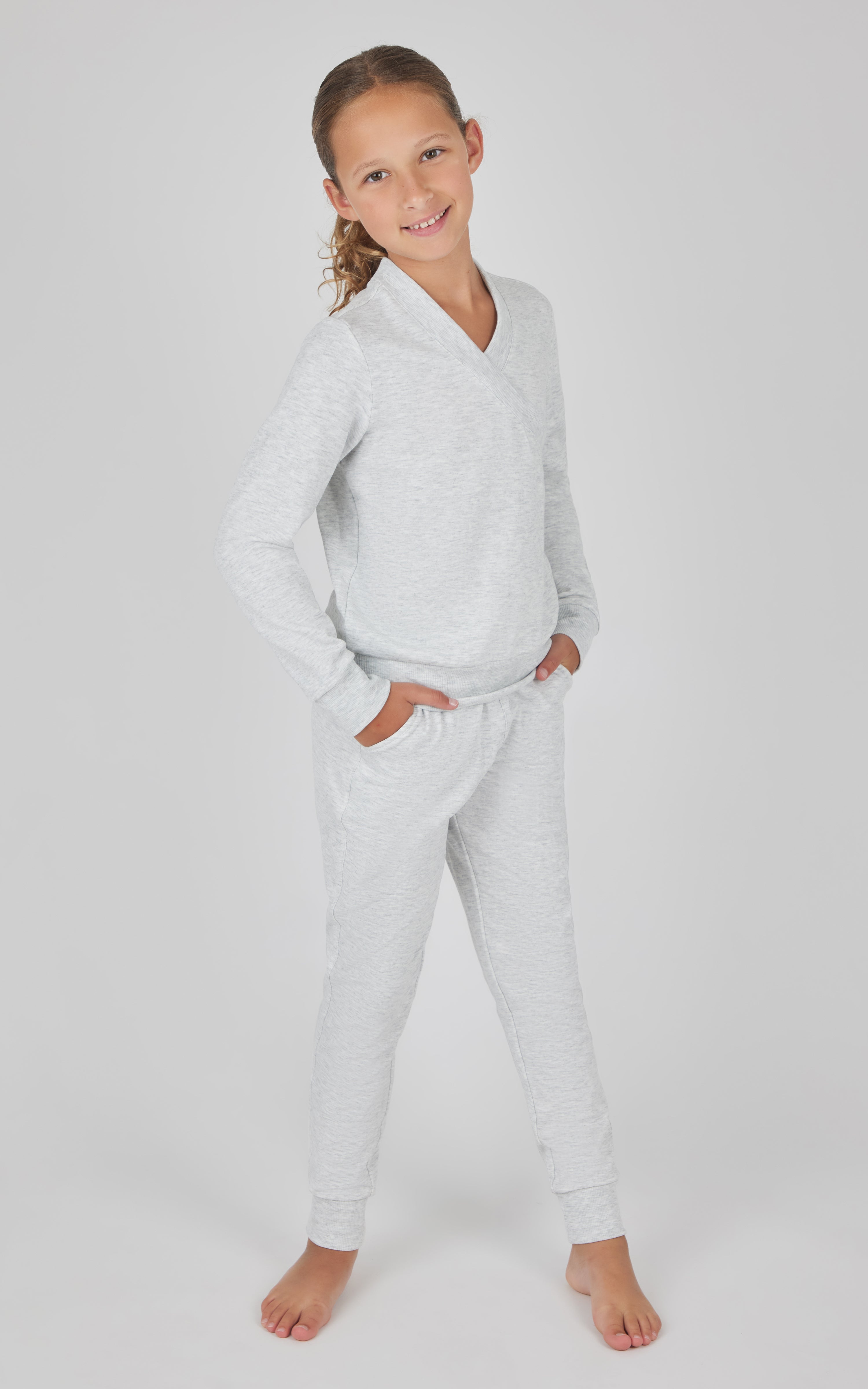 Girls white terry crossover long sleeve top with matching brushed jogger pants set.