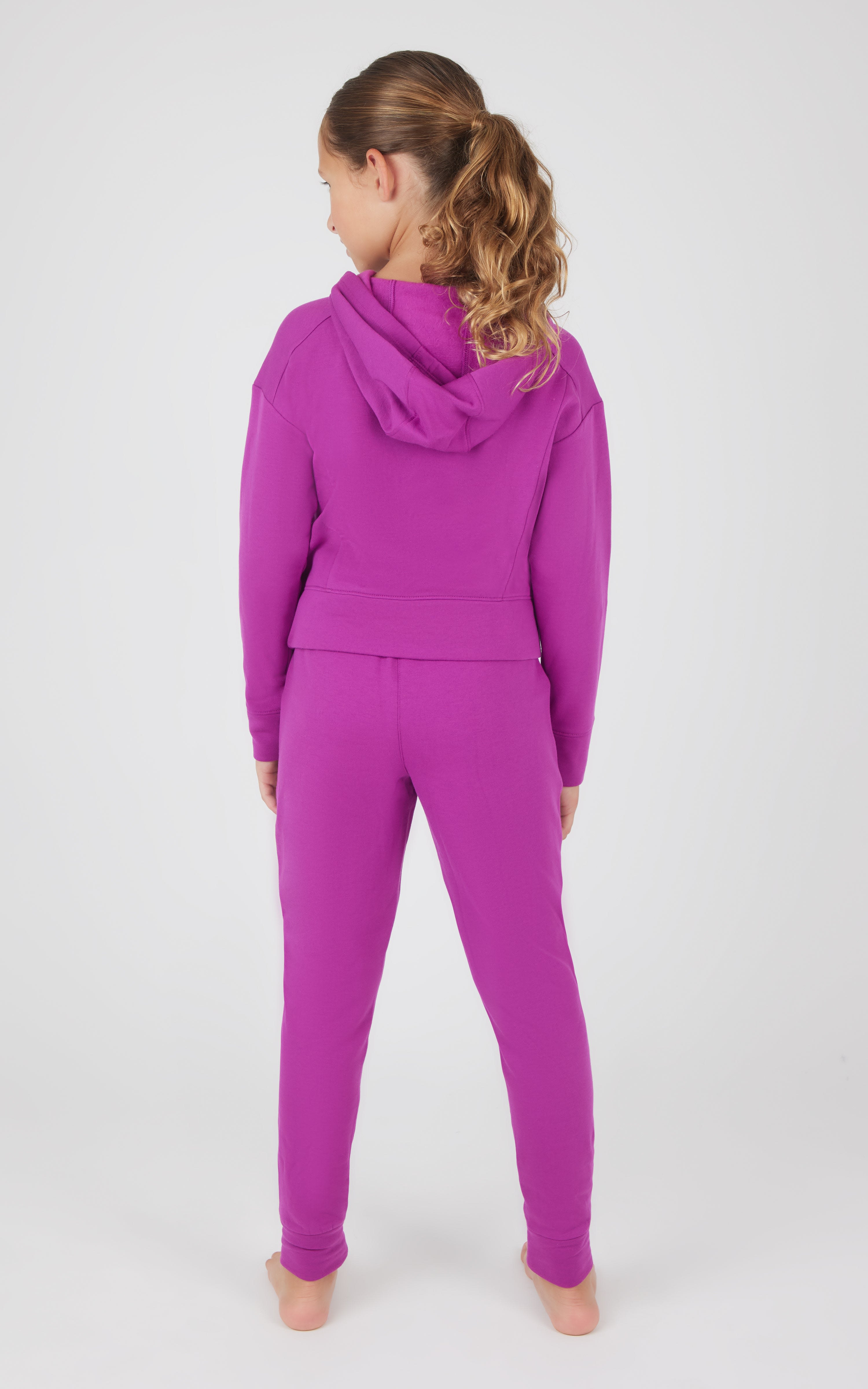 Girls bright purple terry brushed hoodie and matching joggers set, back view.