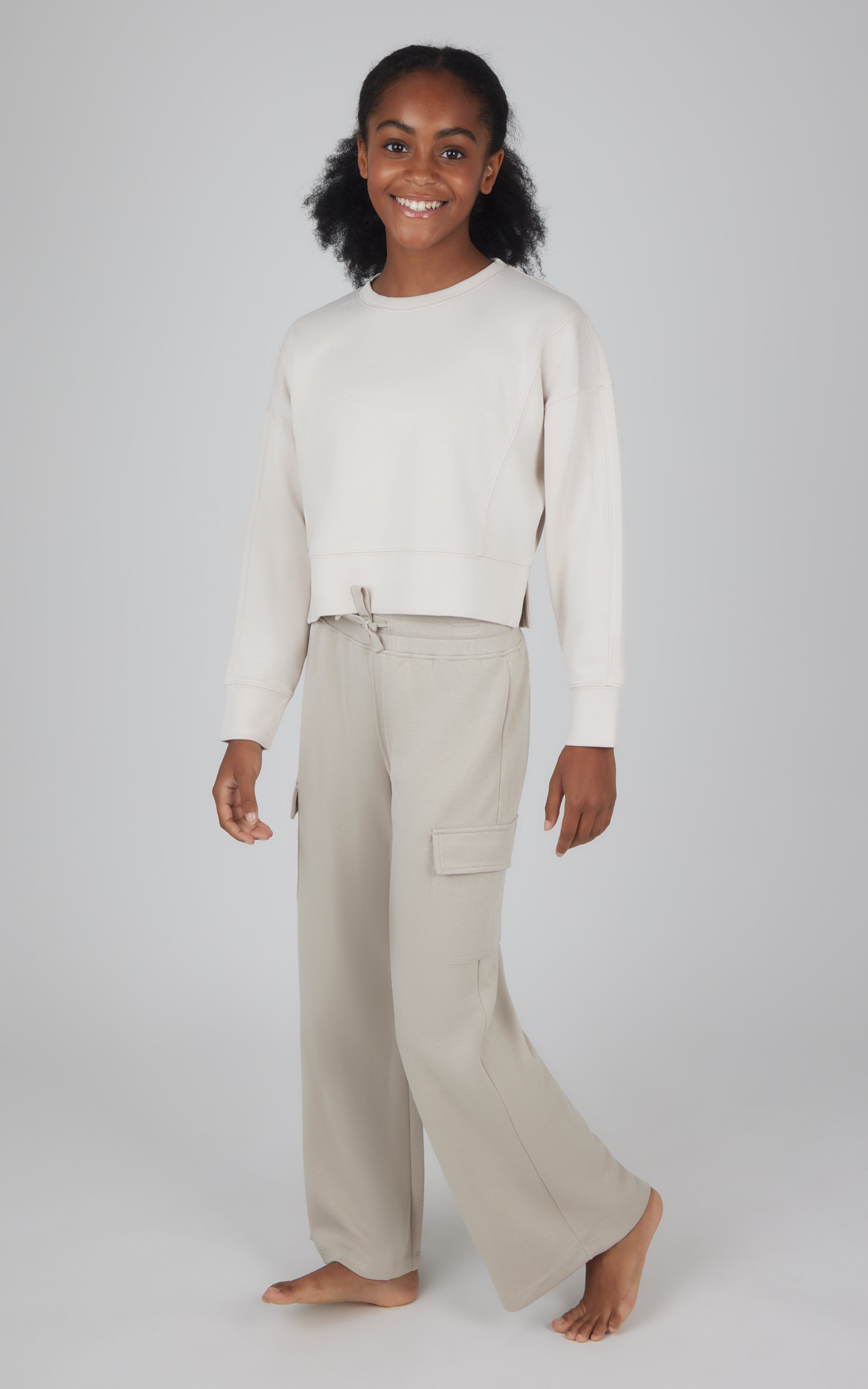 Girls beige Softlite cropped pullover with matching wide-leg cargo pants.