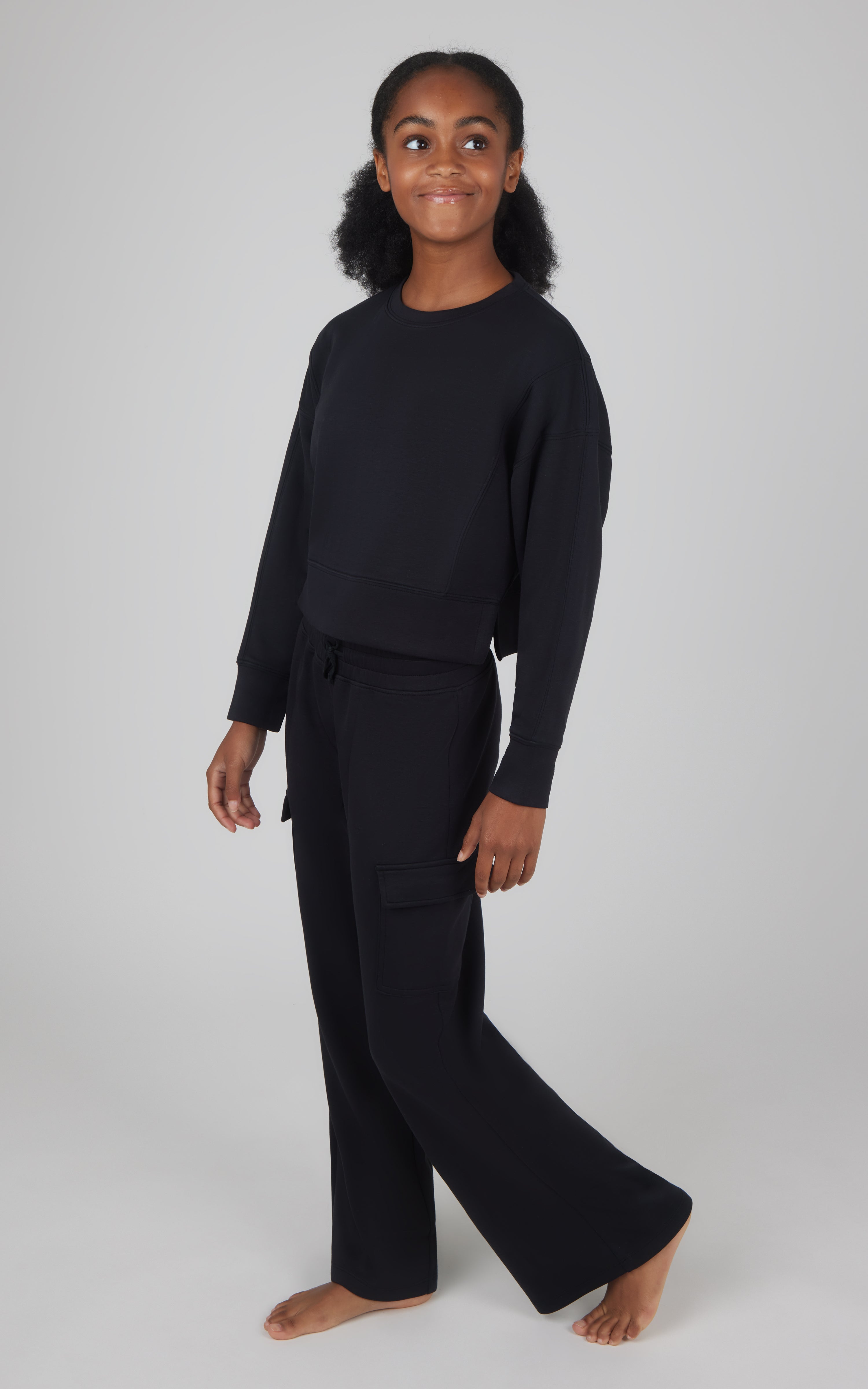 Girls black Softlite cropped pullover with matching wide-leg cargo pants, relaxed fit.