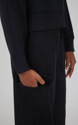 Black softlite cropped pullover with matching wide-leg cargo pants featuring side pockets.