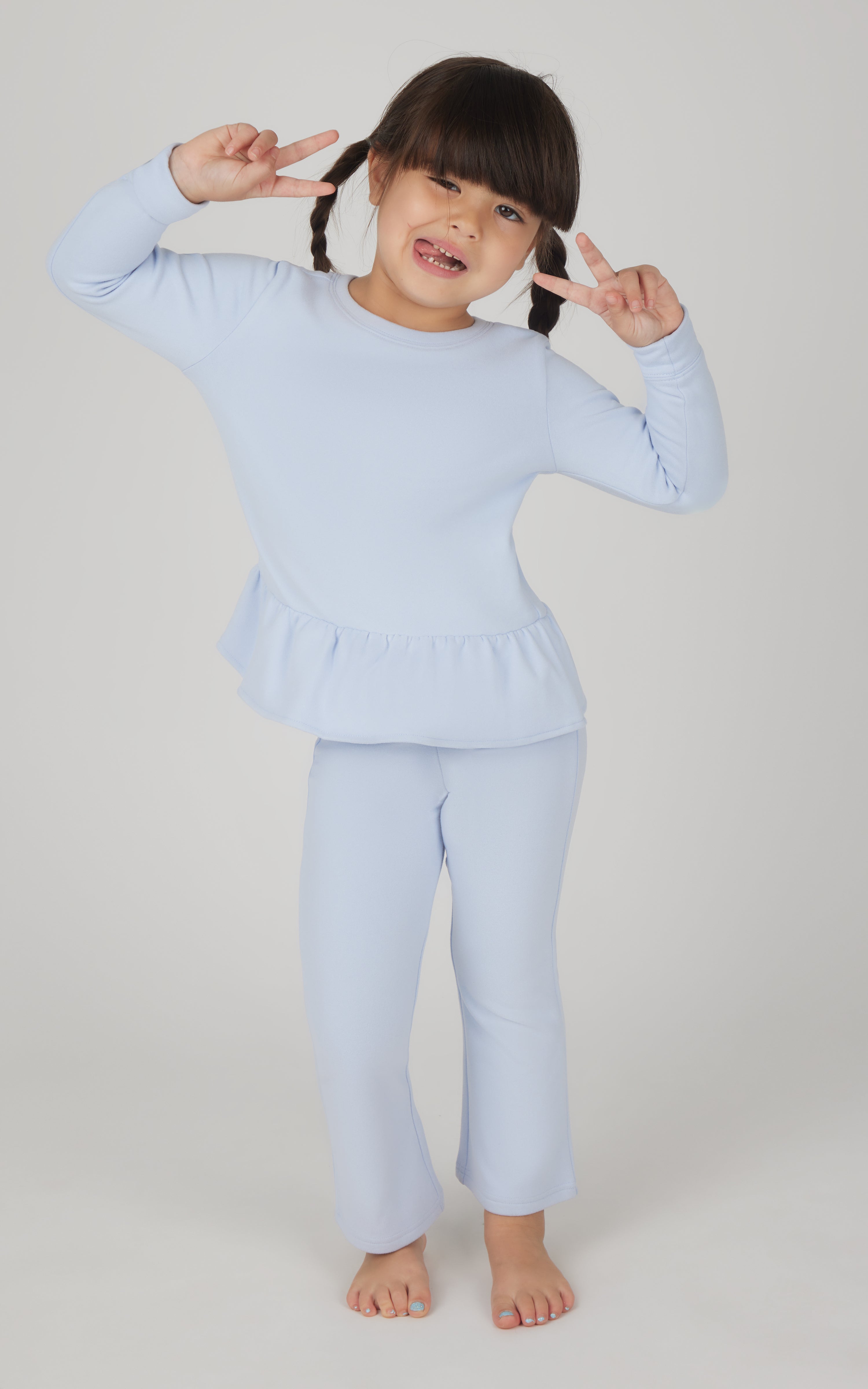 Light blue toddler girls' melange pullover top with ruffled hem and matching flare leg pants.