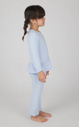 Toddler girl in light blue melange pullover with flare hem and matching flare leg pants.