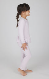 Toddler girl wearing light pink melange pullover top with ruffled hem and matching flare leg pants.