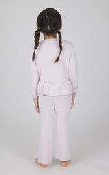 Toddler girl wearing light pink melange pullover top with ruffle hem and matching flare leg pants.