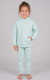 Toddler wearing a mint green brushed terry hoodie and tapered joggers with a front pocket.