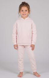 Toddler wearing a pale pink brushed terry hoodie and matching tapered joggers with an elastic waist.