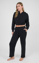 Women's black cropped zip-up hoodie and matching straight-leg pants in a soft sandwash finish, with front pockets.