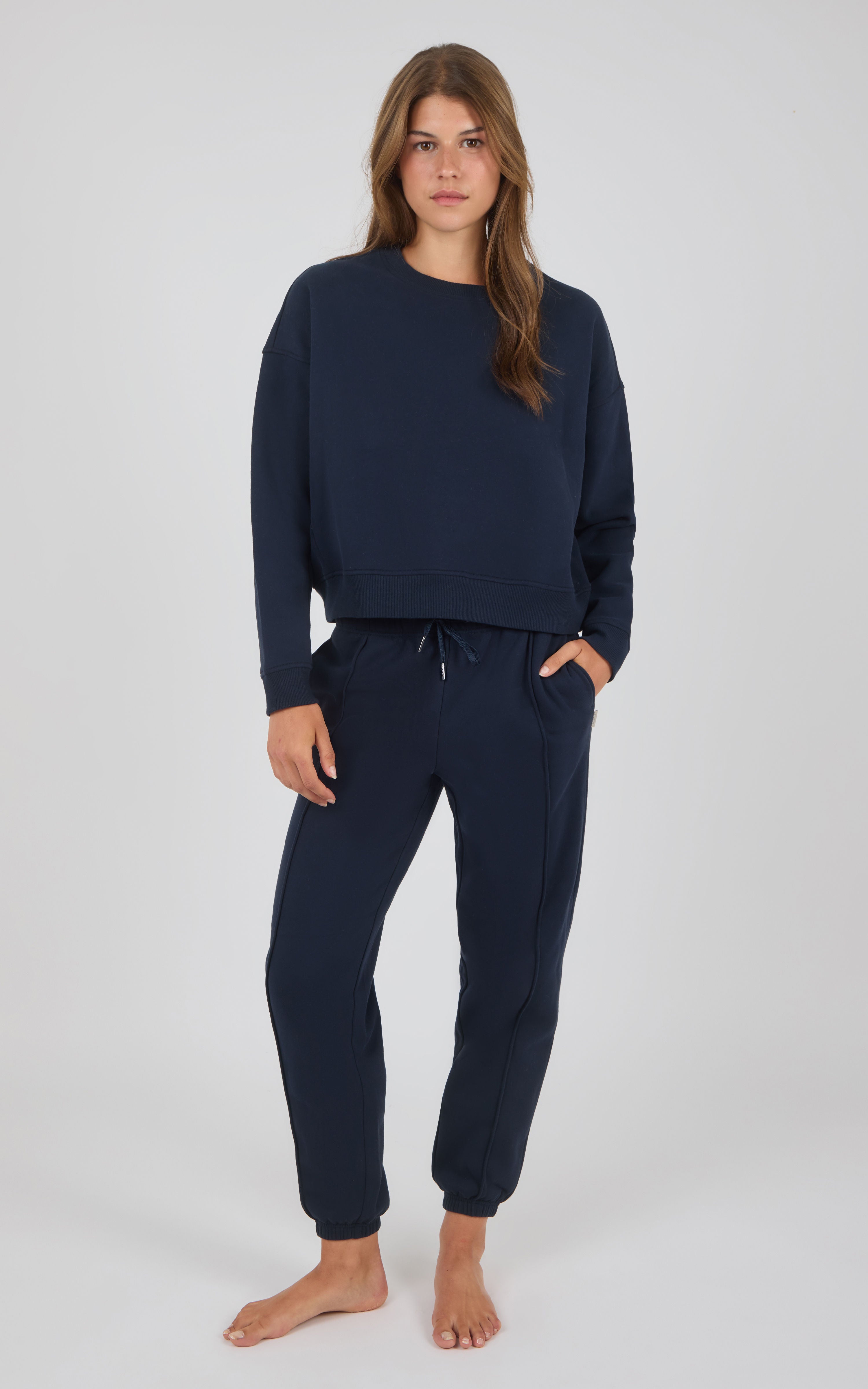 Navy-blue relaxed fit sweatshirt and jogger pants with elastic cuffs and drawstring waist.