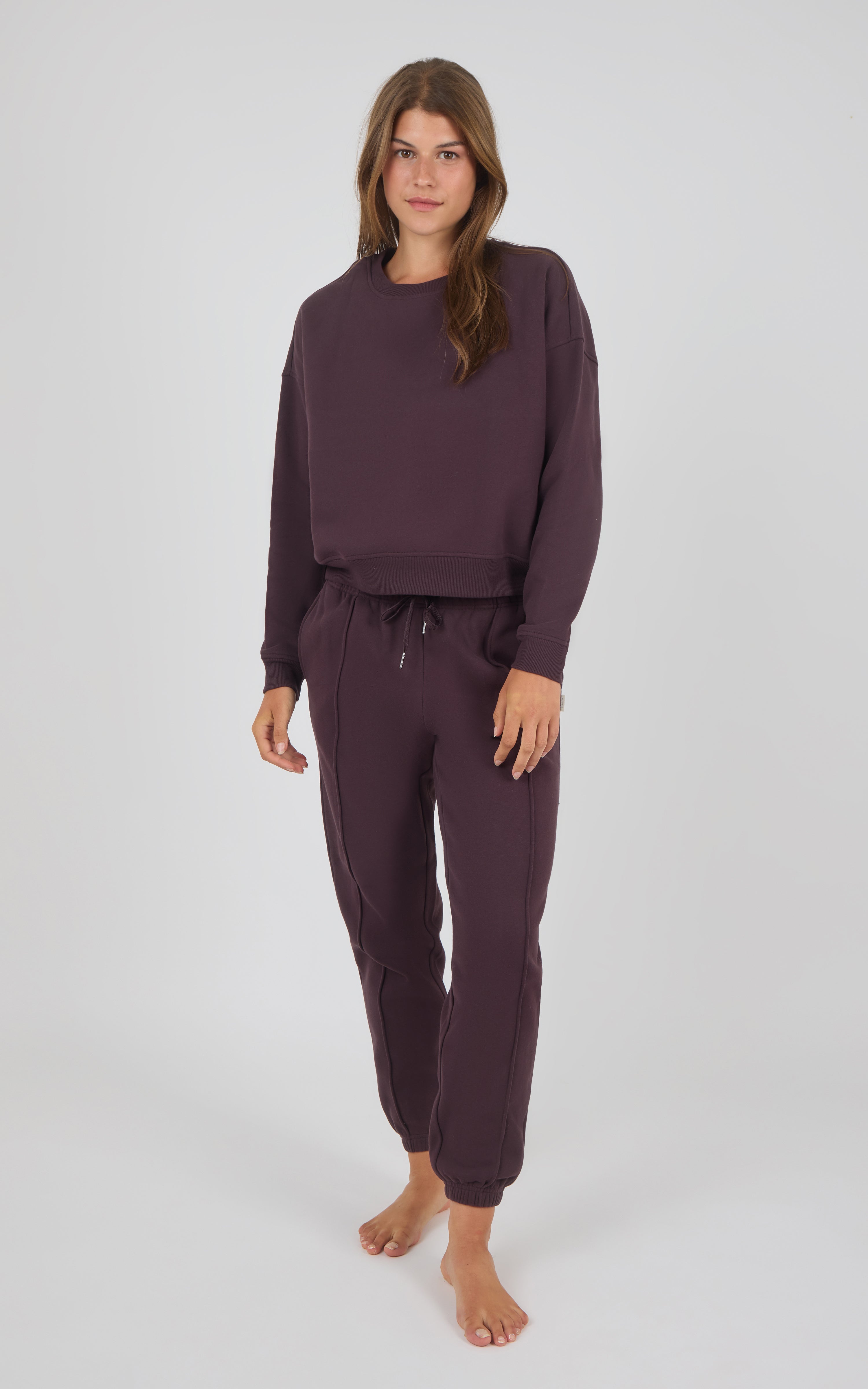 Midnight Berry long-sleeve crewneck sweatshirt and matching pintuck jogger pants set on female model.