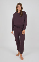 Midnight Berry long-sleeve crewneck sweatshirt and matching pintuck jogger pants set on female model.