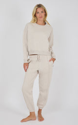 Light oatmeal knit crewneck sweatshirt and matching pintuck jogger pants with drawstring waist.