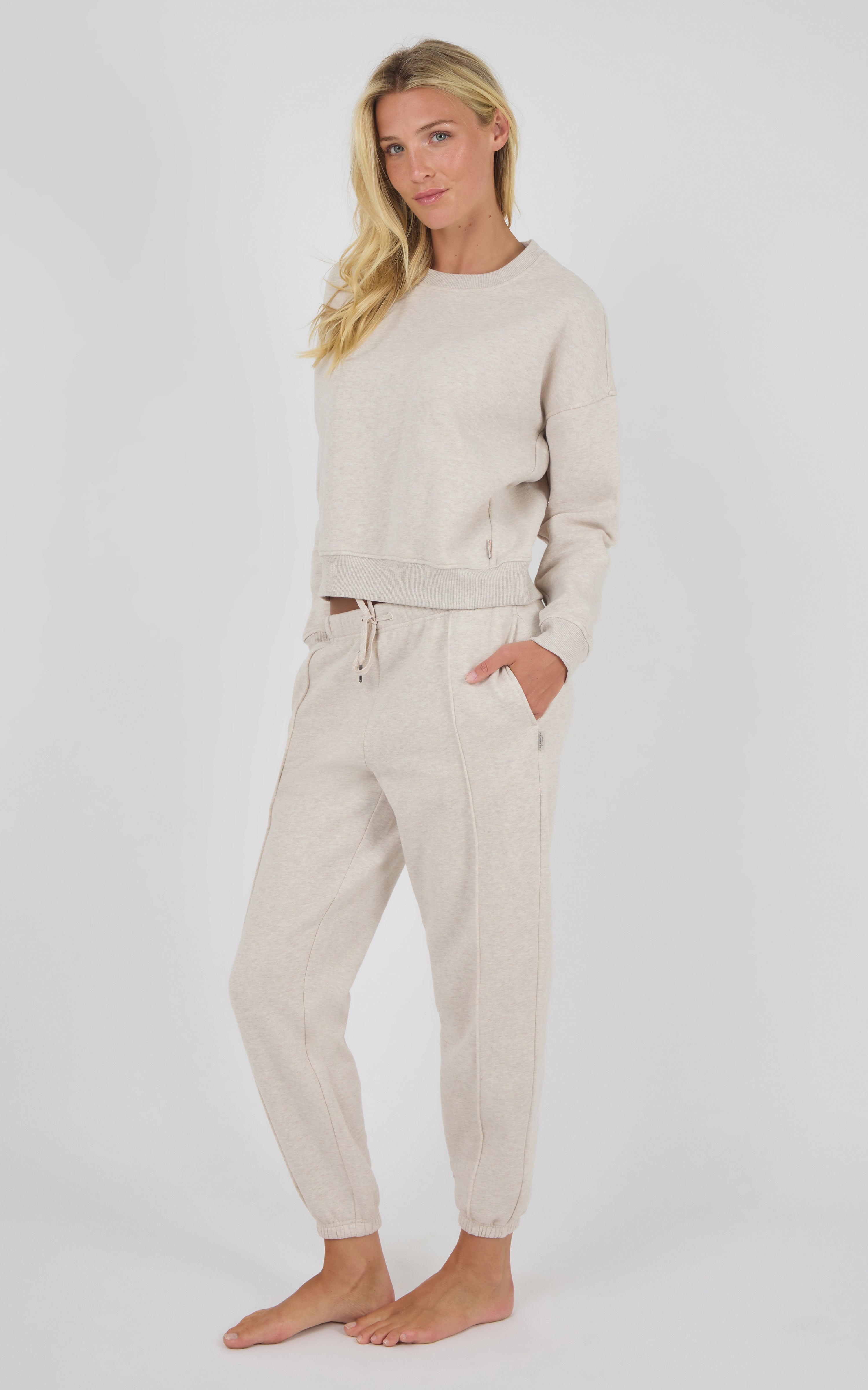 Beige long-sleeve knit top with matching pintuck jogger pants, relaxed fit, drawstring waist.