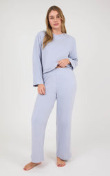 Woman modeling a light lavender marled lounge set with a boxy long-sleeve top and straight-leg pants.