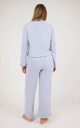 Back view of a light lavender marled knit set with a cropped long-sleeve top and straight-leg pants.