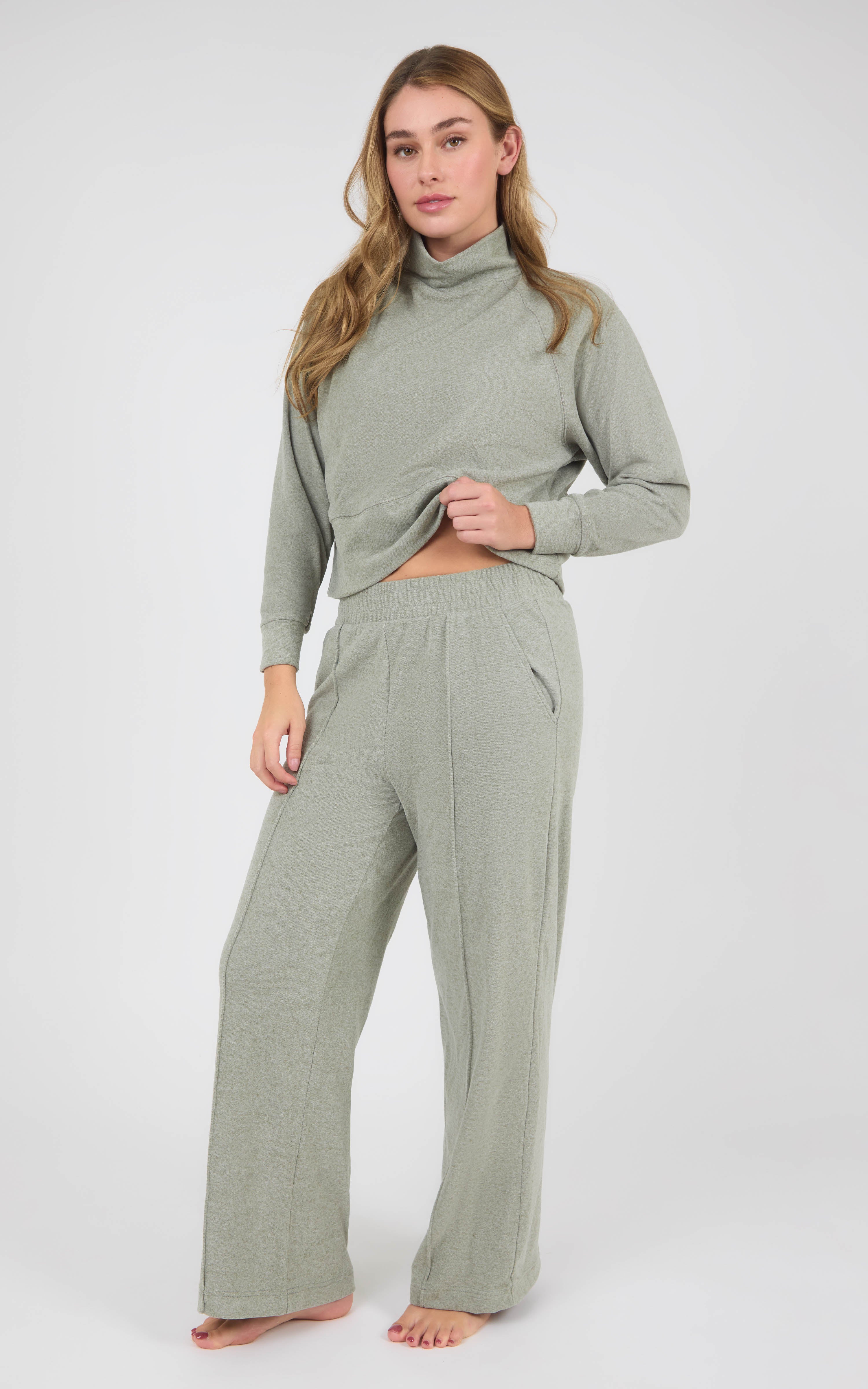 Model wearing a sage gray marled long-sleeve pullover and matching wide-leg pants with pintuck detailing.