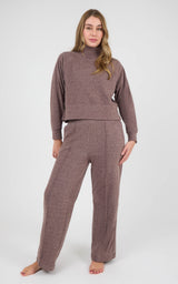Model wearing a heathered mauve long-sleeve raglan pullover with matching pintuck wide-leg pants.
