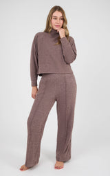 Woman wearing a mauve marled knit set with a long-sleeve raglan pullover and wide-leg pants.