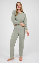 Woman wearing a sage gray marled long-sleeve crewneck pullover and matching wide-leg pants with side pockets.