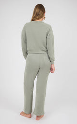 Woman wearing a sage gray marled knit set with a long-sleeve crewneck top and wide-leg pants.