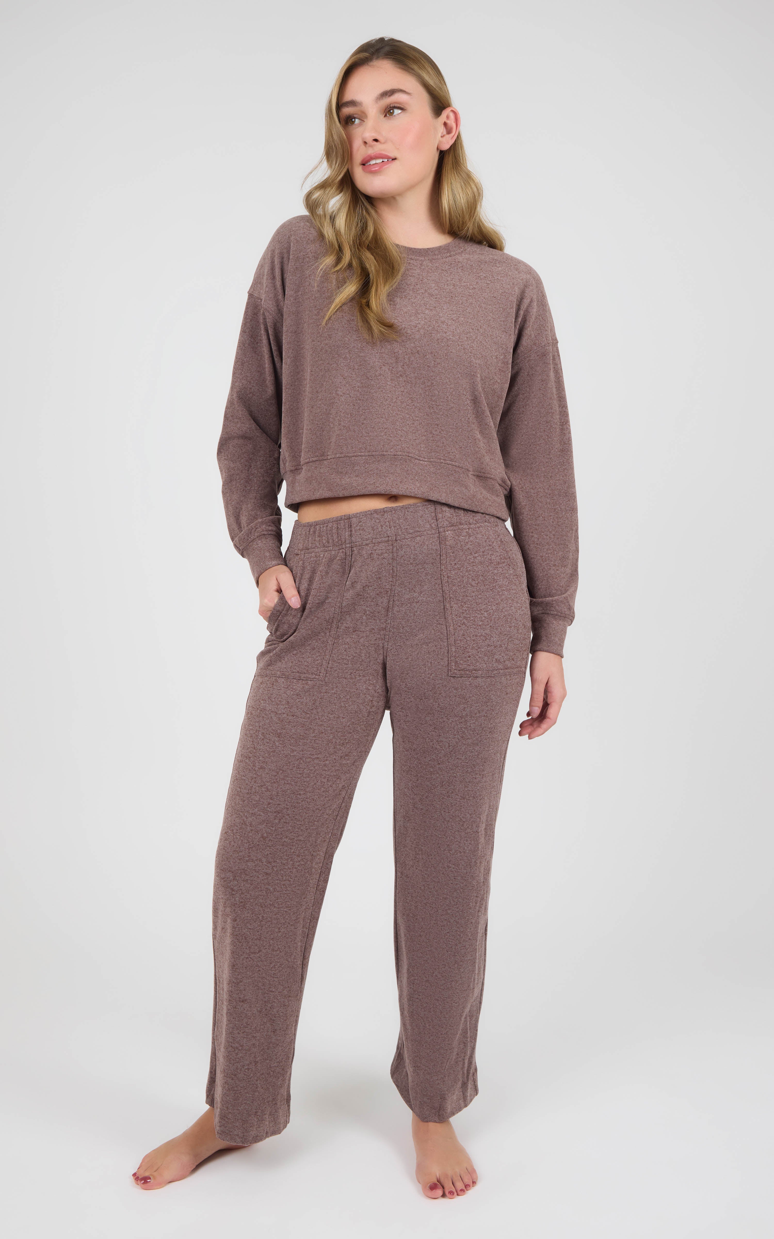 Woman wearing a mauve marled crew-neck long-sleeve pullover and matching wide-leg pants with side pockets.