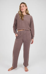 Woman wearing a mauve marled crew-neck long-sleeve pullover and matching wide-leg pants with side pockets.