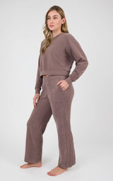 Woman wearing a taupe marled long-sleeve crewneck and matching wide-leg pants with side pockets.